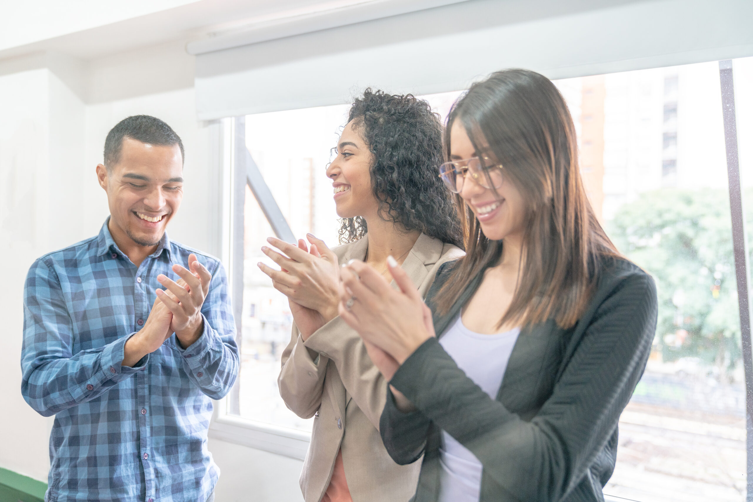 employees standing together and clapping during employee recognition event