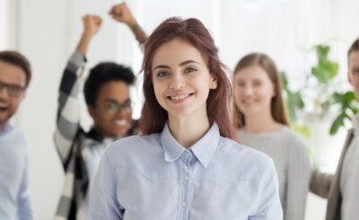 A team celebrating a woman at work