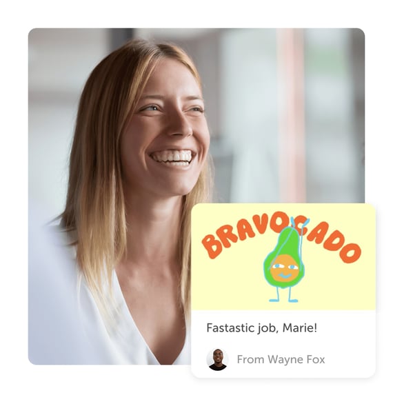 Woman smiling at a digital thank you card by Kudoboard that reads 'Bravocado'