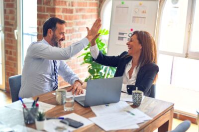 Coworkers high-fiving together