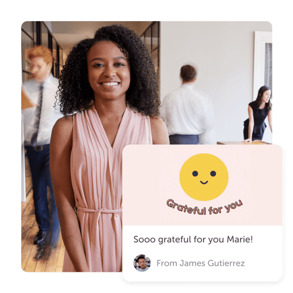 Person smiling in office with "grateful" post