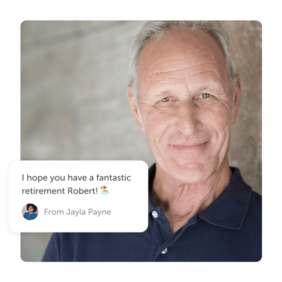 Older man smiling with a "retirement" post