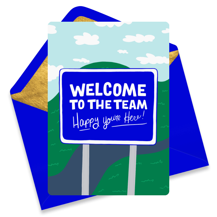 Bright welcome eCard with a road sign reading 'WELCOME TO THE TEAM Happy you're Here!' set against rolling hills and a blue sky with clouds.