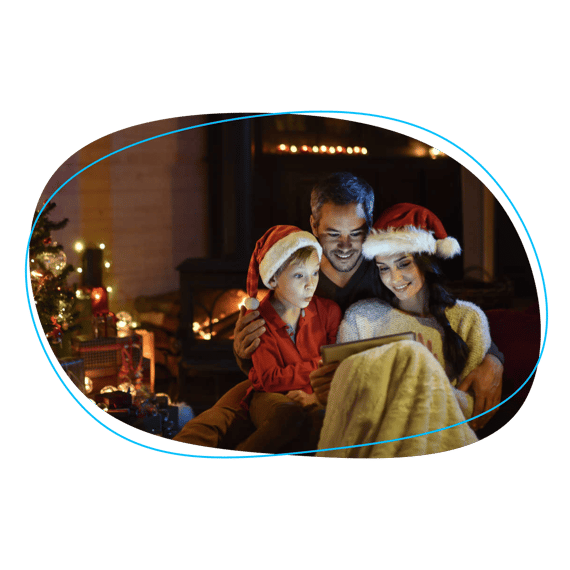 Family in Santa hats looking at tablet